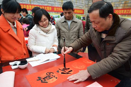 图一为1月30日，洛江区书法家郭永金在罗溪镇龟峰岩书写家风春联。（林升  姚秋惠   摄影报道）