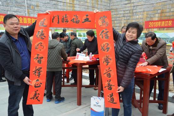 图二为1月30日，罗溪镇群众黄紫雄、赖莲珠夫妇高兴地展示书法名家写的家风春联。（林升  姚秋惠   摄影报道）